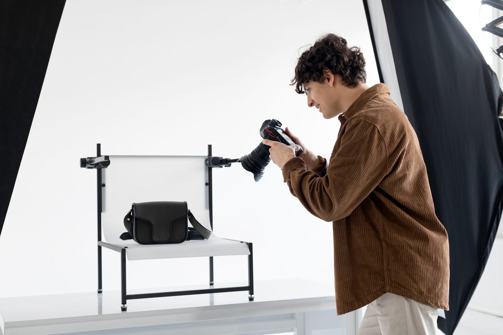 From vision to reality. Young photographer guy making content photos for modern shop, photographing